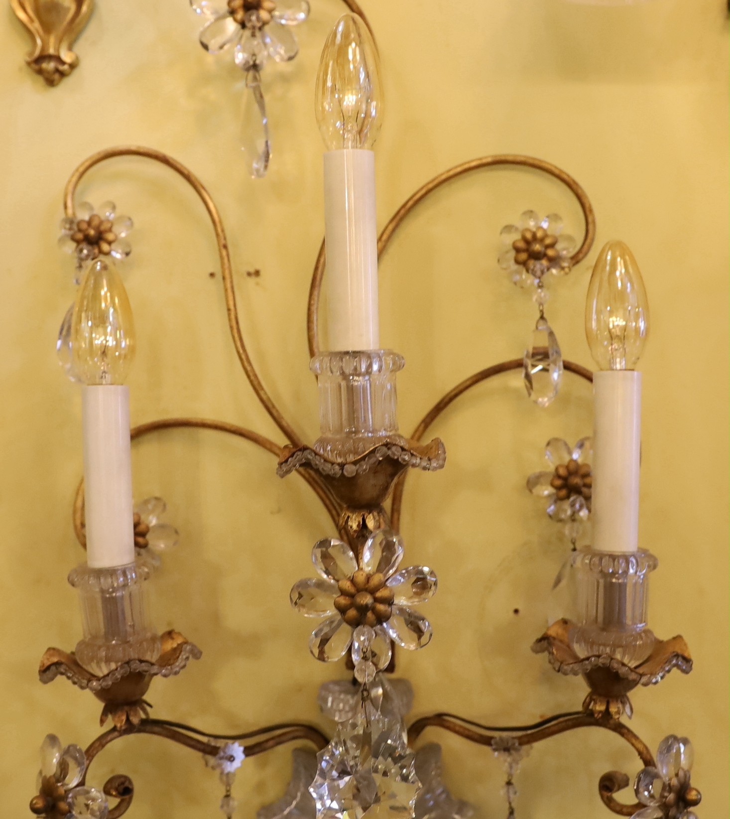 An early 20th century French gilt metal and Baccarat crystal triple branch wall light, height 68cm. width 36cm